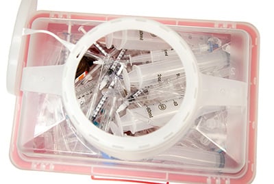 Treatment of biohazardous sharps and sharp containers
